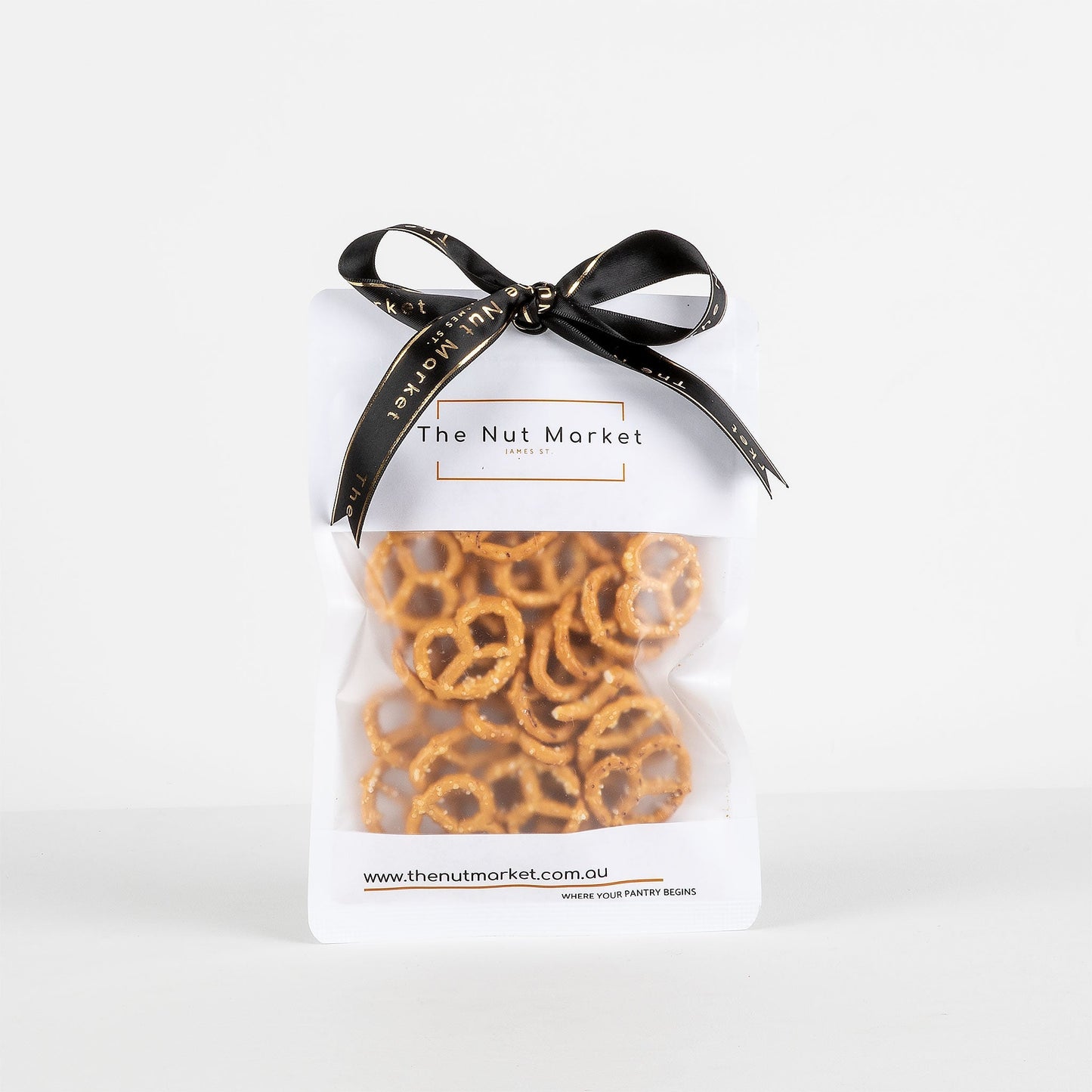 Bag of pretzels from The Nut Market with a black ribbon on a white background