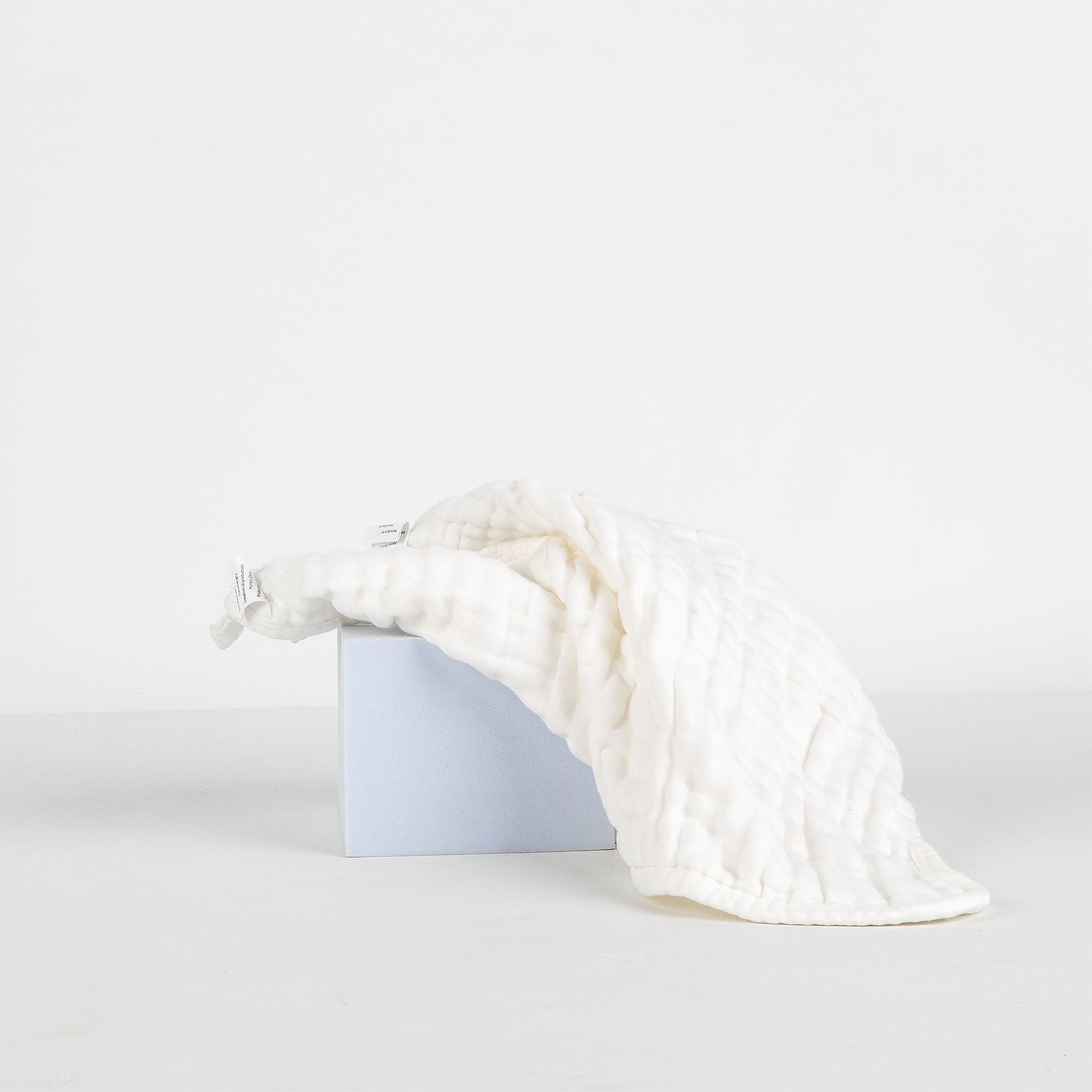 White textured face cloth on a white background