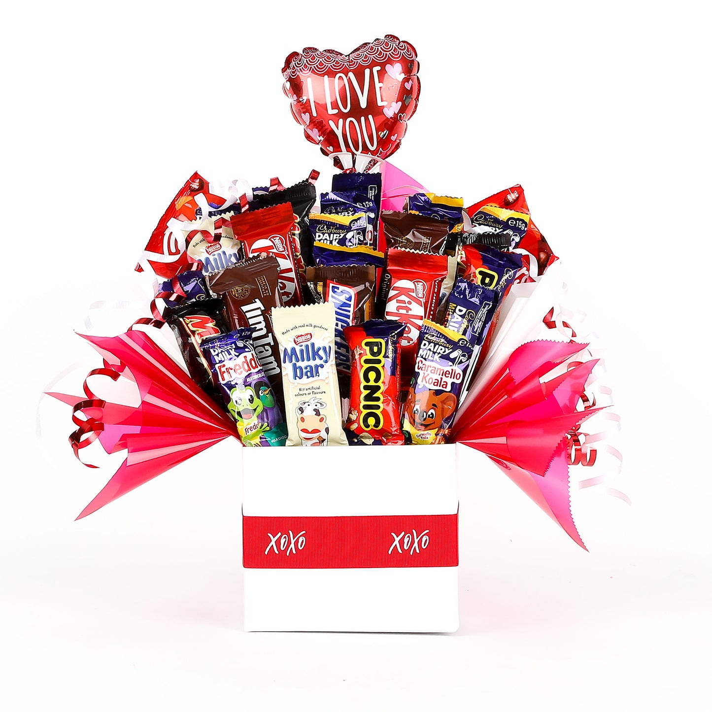 Chocolate bouquet with various chocolate bars & a "I Love You" balloon in a box labeled 'XOXO' on a white background