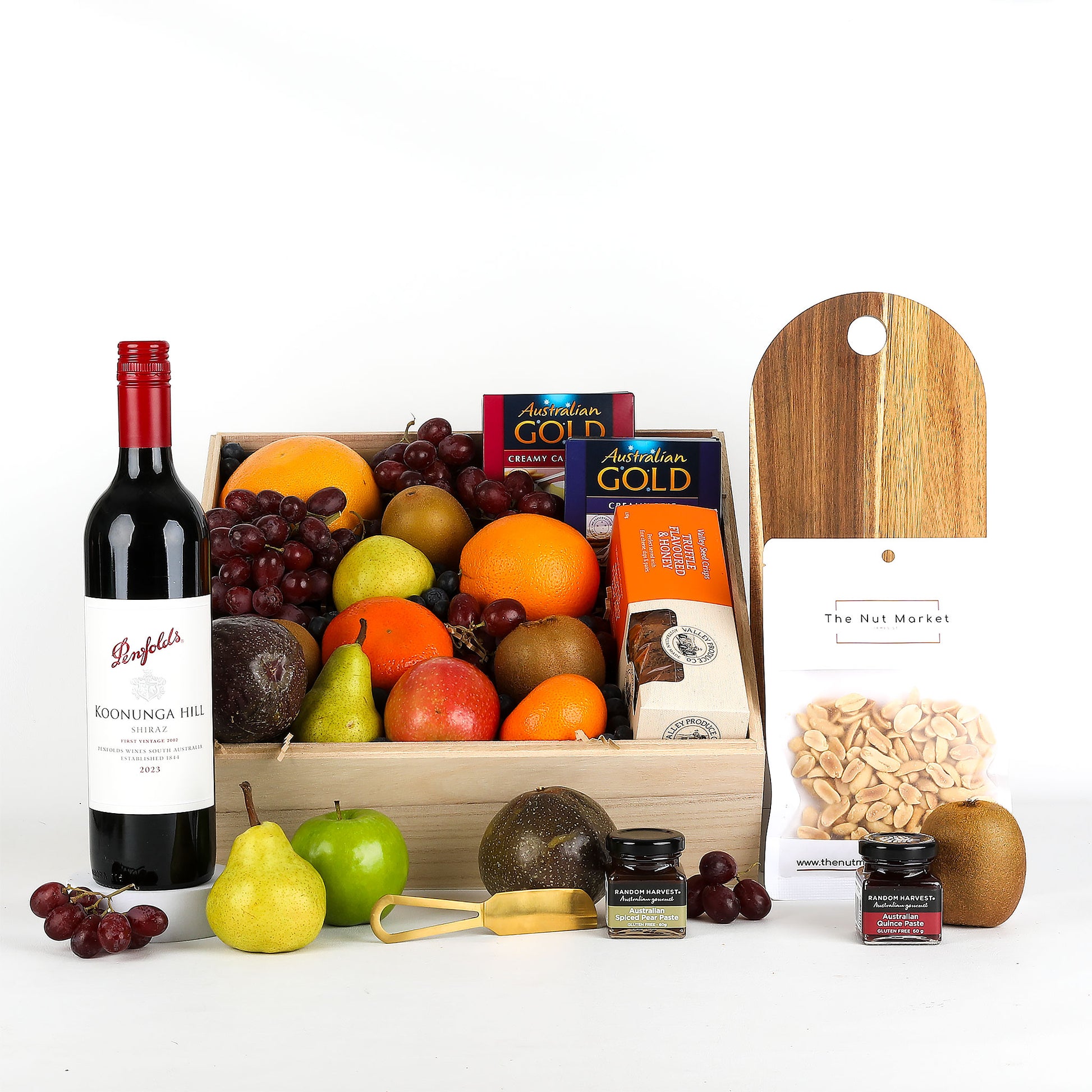 Fruit basket with red wine, treats and cheese board on a white background