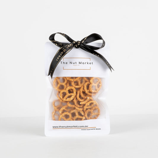 Bag of pretzels from The Nut Market with a black ribbon on a white background