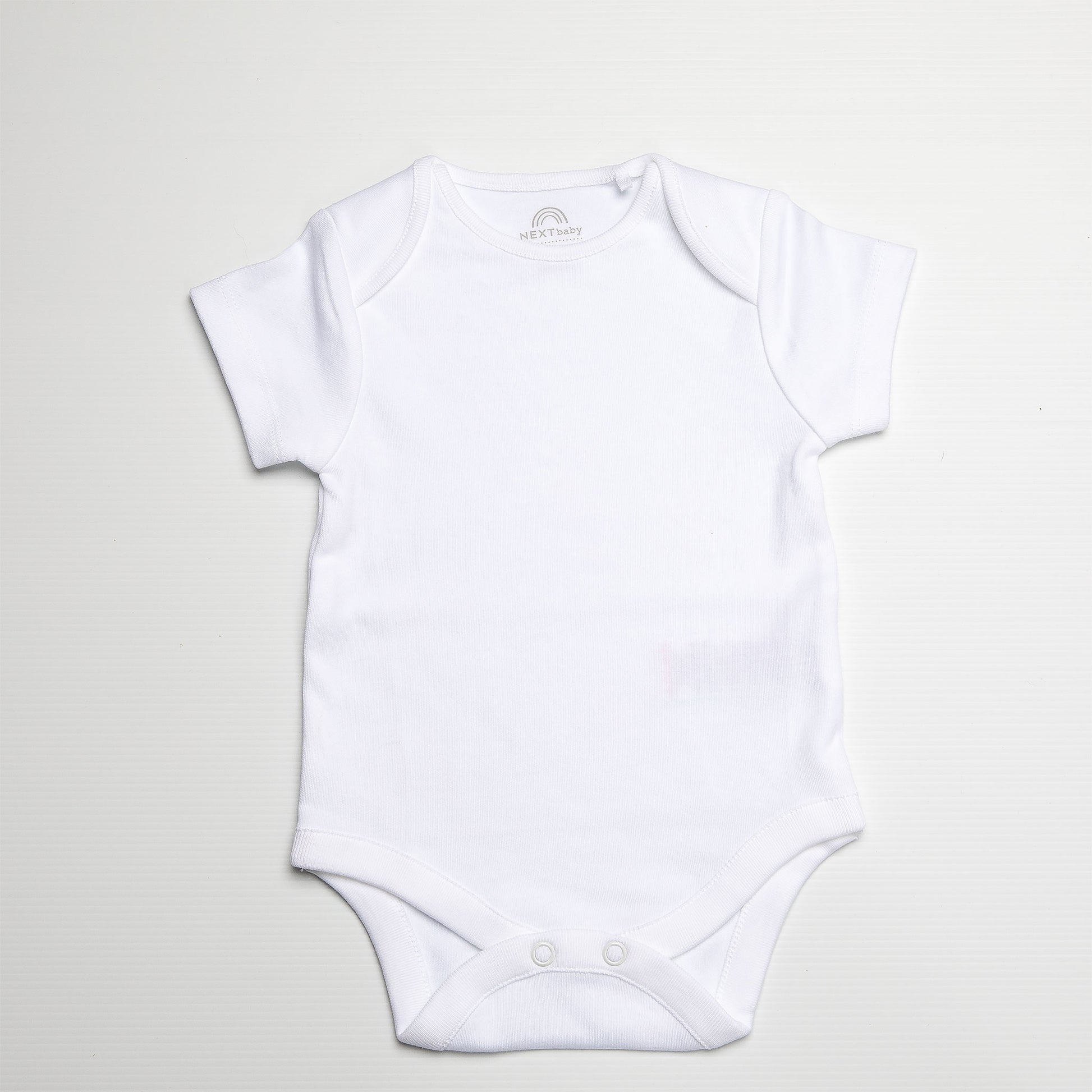 White baby onesie on a light gray background