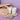 Tilley products including a candle, lotion, and decorative items on a purple surface.