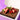 Chocolate brownie with strawberries on a white plate, set against a purple background.