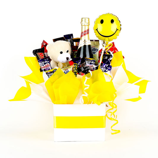 Gift basket with a teddy bear, wine, snacks and balloon on a white background