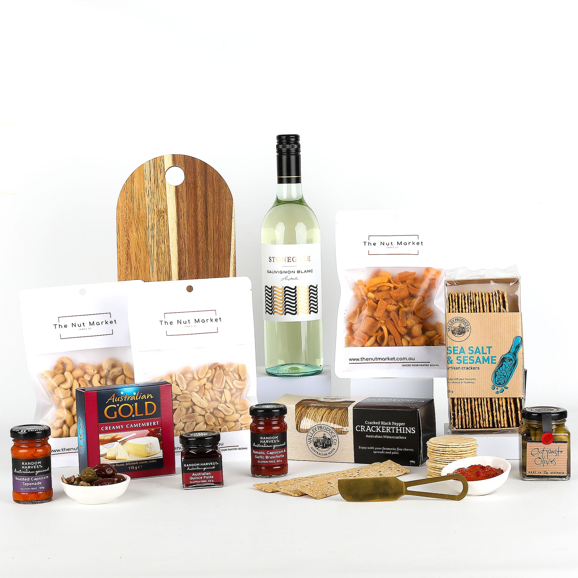 Assorted food items including wine, nuts, spreads & cheese board on a white background