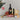 Baileys bottle with Christmas-themed items including cookies and pudding on a gray background