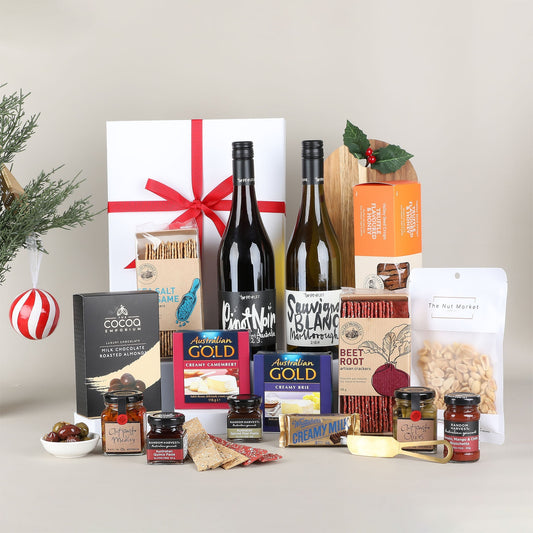 Assorted gourmet food and wine gift set on a neutral background