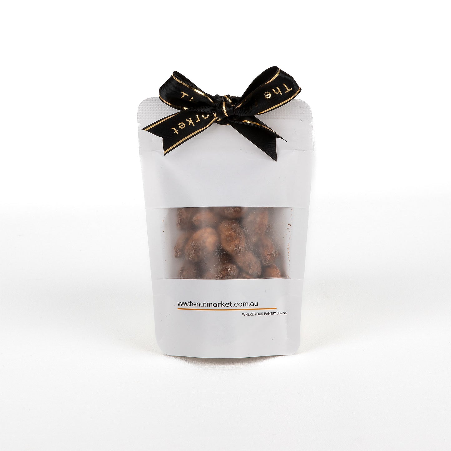 White packaging of roasted peanuts with a black bow on a white background.