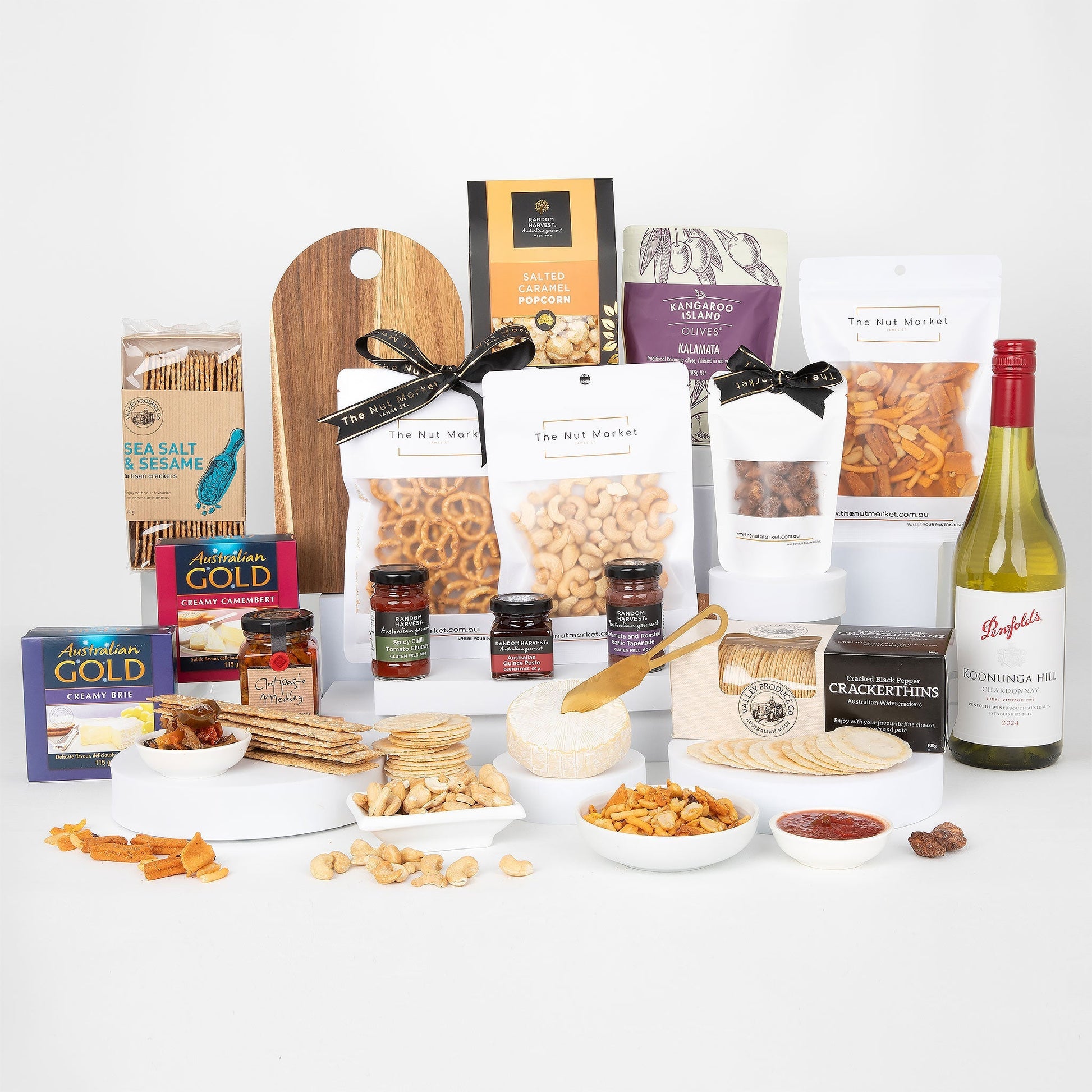 Assorted food items including nuts, crackers, and wine on a white background