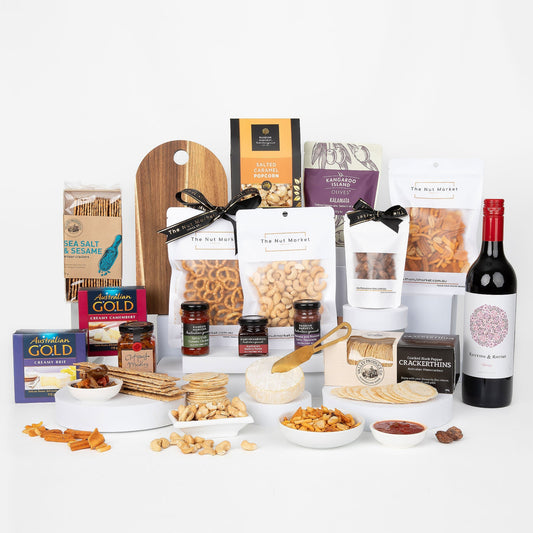 Assorted food items including nuts, crackers, and a bottle of wine on a white background