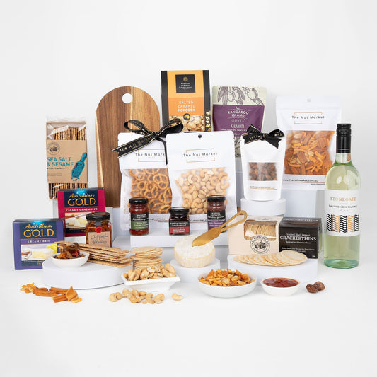 Assorted food items including nuts, cheese, and wine on a white background