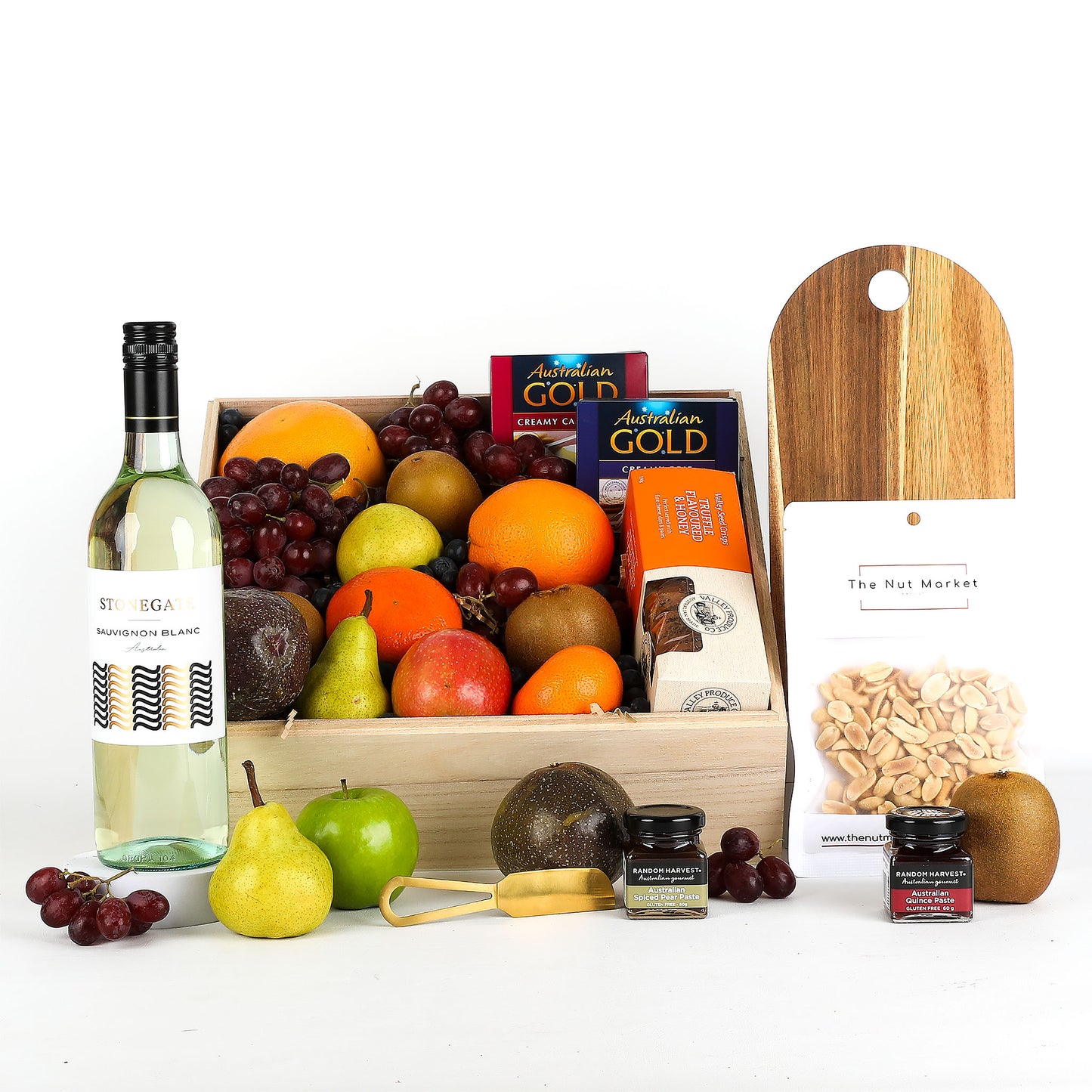 Fruit basket with white wine, treats and cheese board on a white background