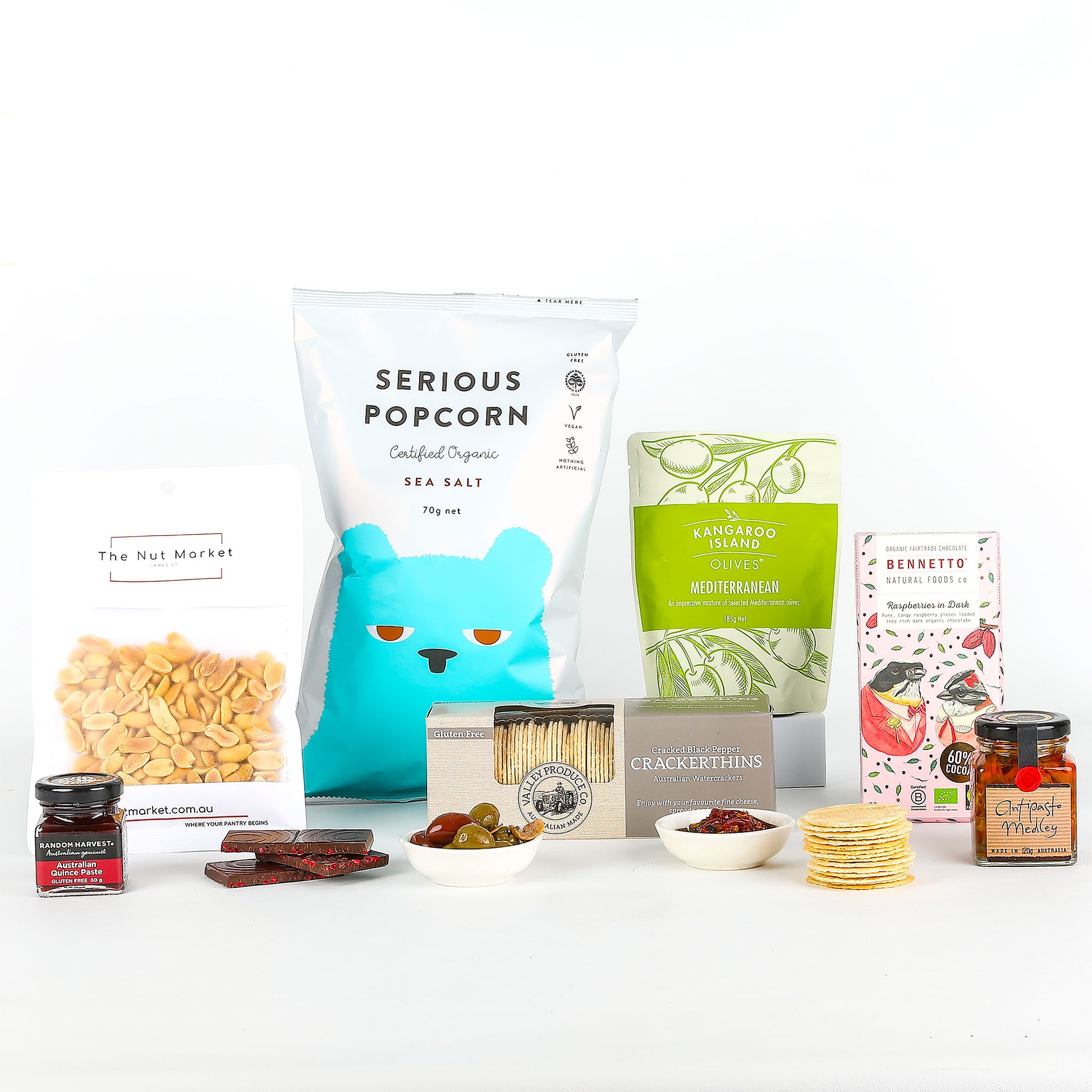 Assorted snacks and products including popcorn, nuts, and chocolate on a white background