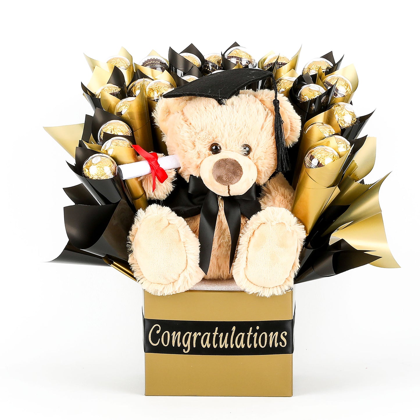 Graduation-themed teddy bear with a bouquet of chocolates wrapped in black & gold in a box labeled 'Congratulations'.