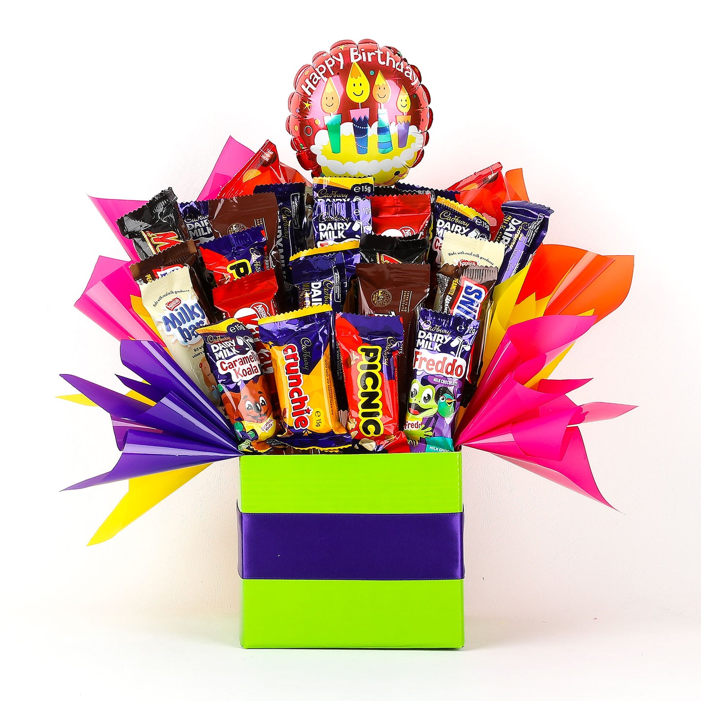 Colorful gift box filled with various chocolates and a birthday-themed balloon on a white background