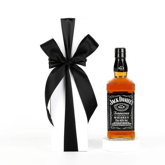 Jack Daniel's whiskey bottle with a black ribbon on a white background