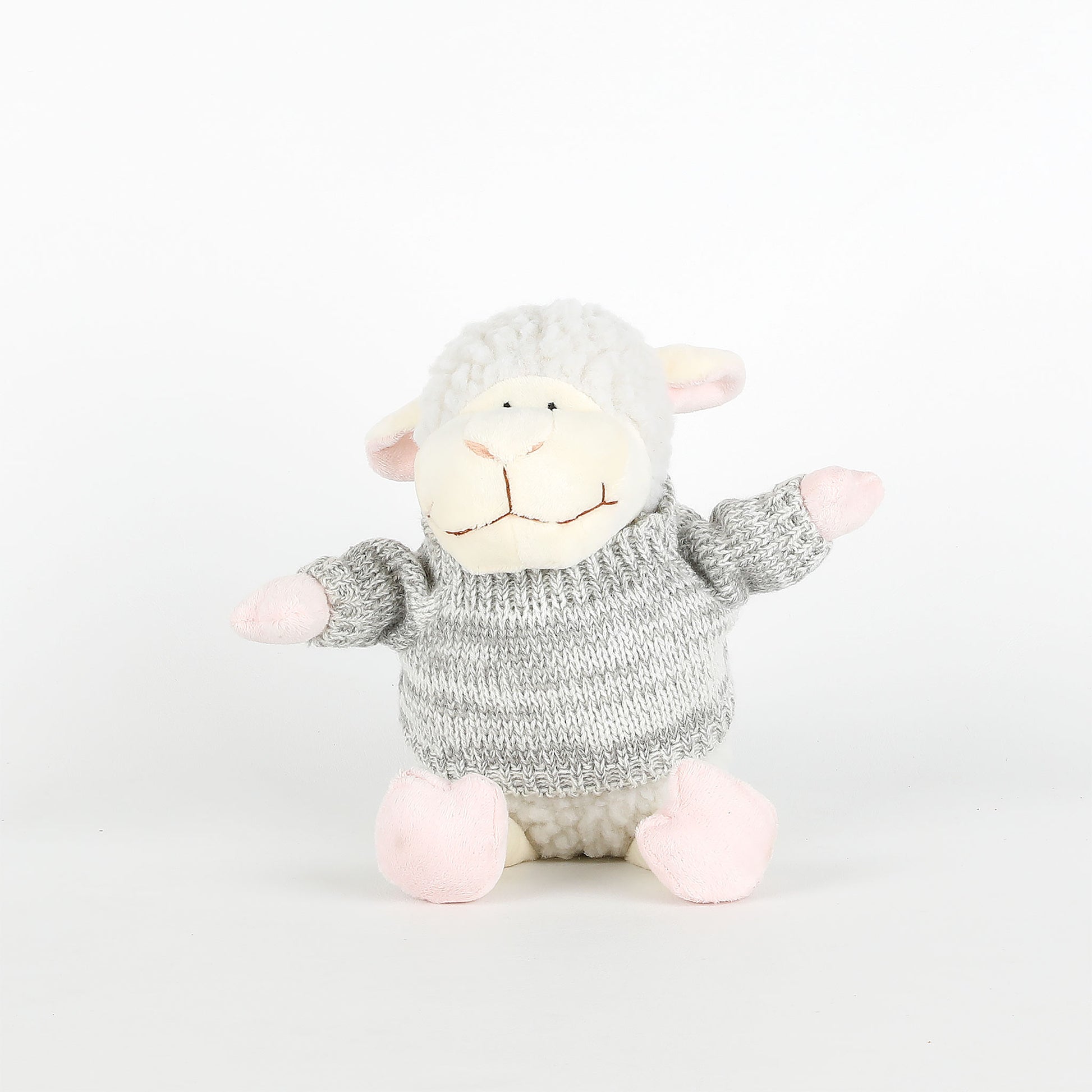 Plush toy sheep with a knitted sweater on a white background