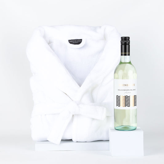 Bottle of wine & white bathrobe on a white background