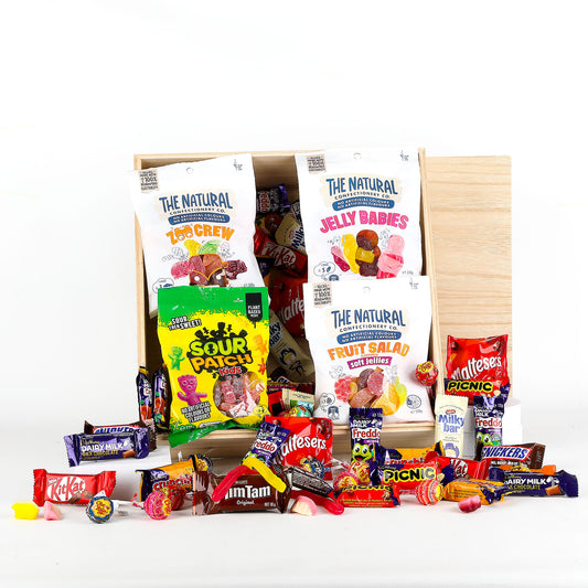 Assorted candy and snack box with visible brand names on a white background