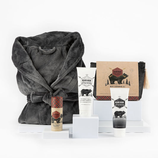 Pamper set with gray robe and skincare products on a white background