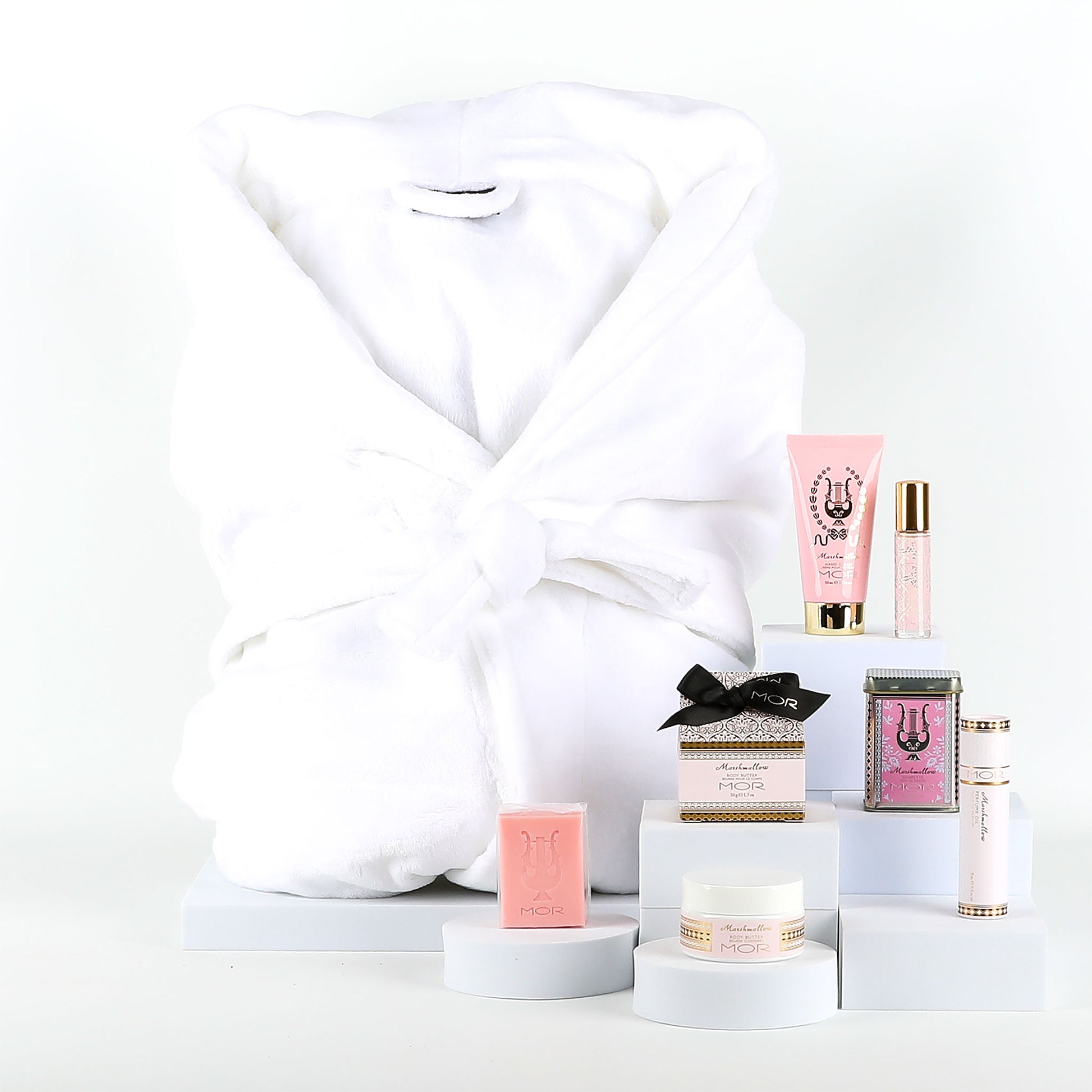 Pamper package including bathrobe and a collection of MOR Marshmallow mini treats on a white background.