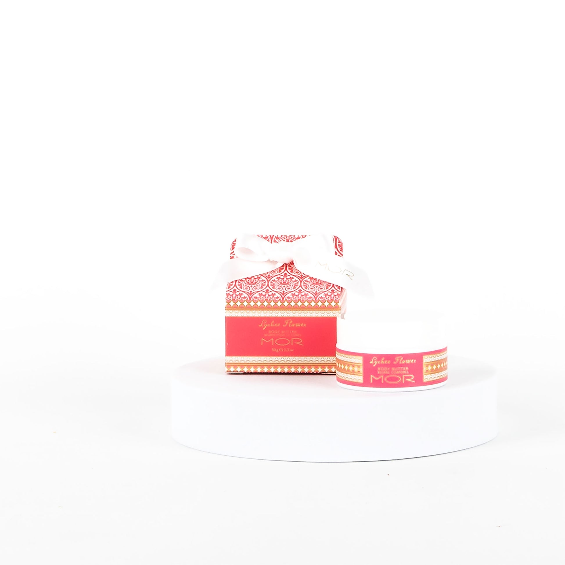 Pink MOR product on a white pedestal with a white background