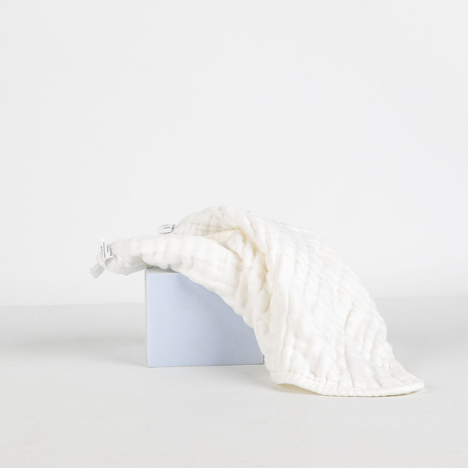 White textured face cloth on a white background