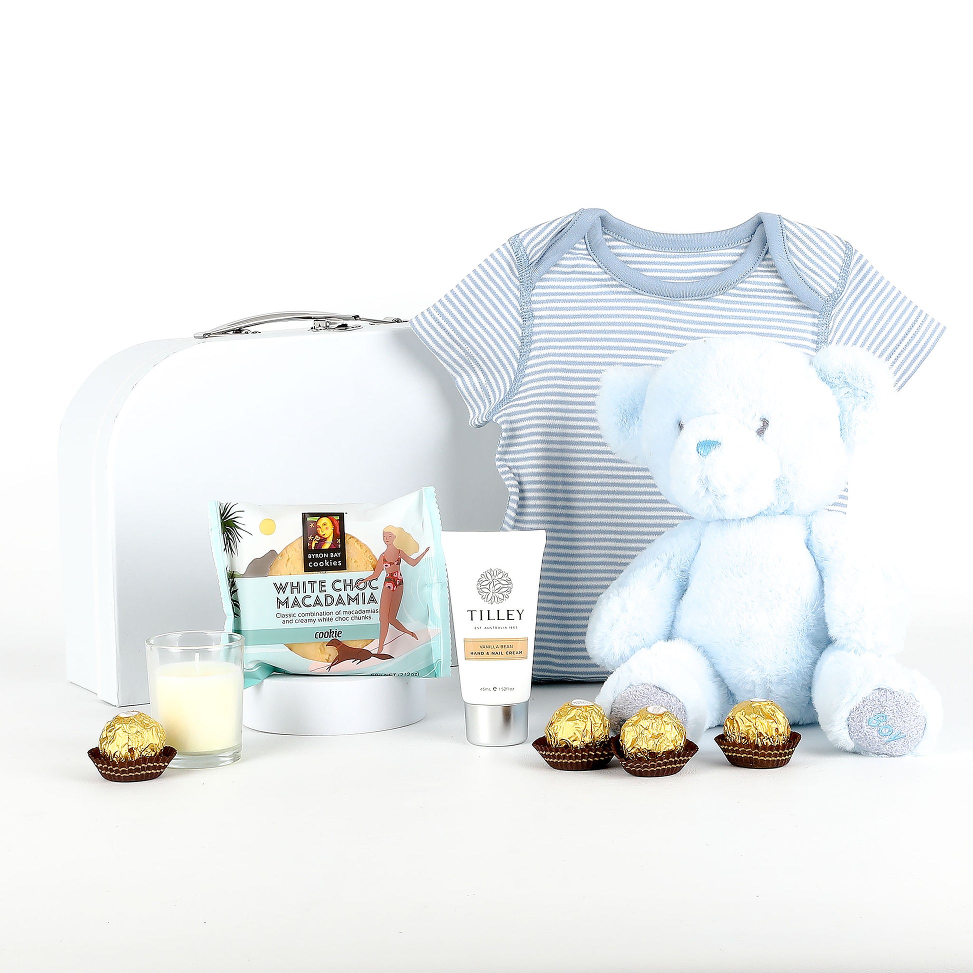Baby gift set with striped onesie, teddy bear, and assorted items on a white background