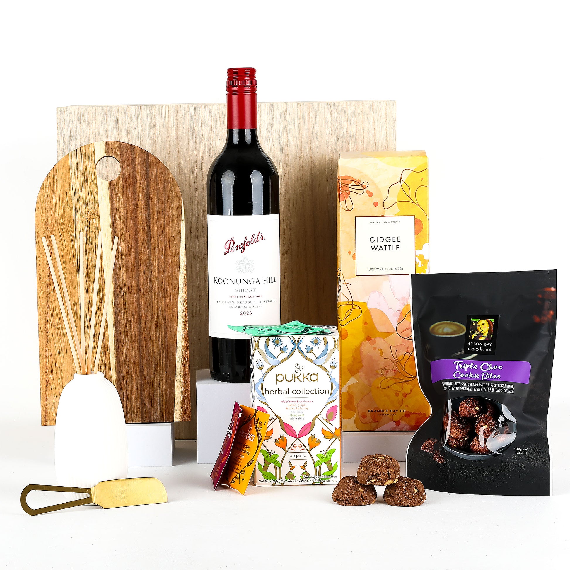 Gourmet gift set with wine, snacks, and tea on a white background