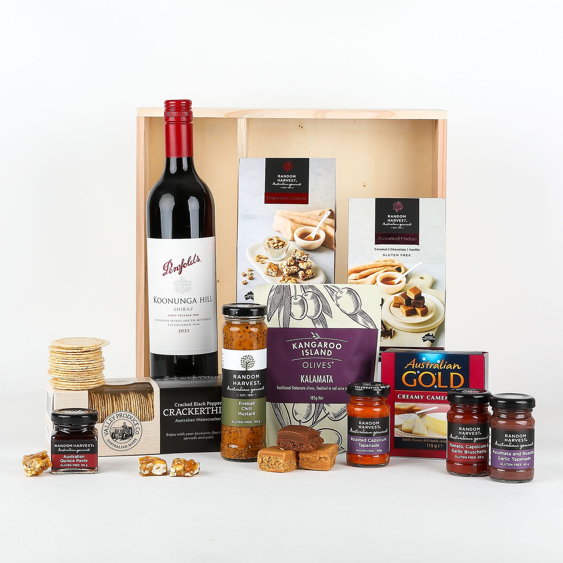 Gourmet gift set with wine, snacks, and jams in a wooden box.