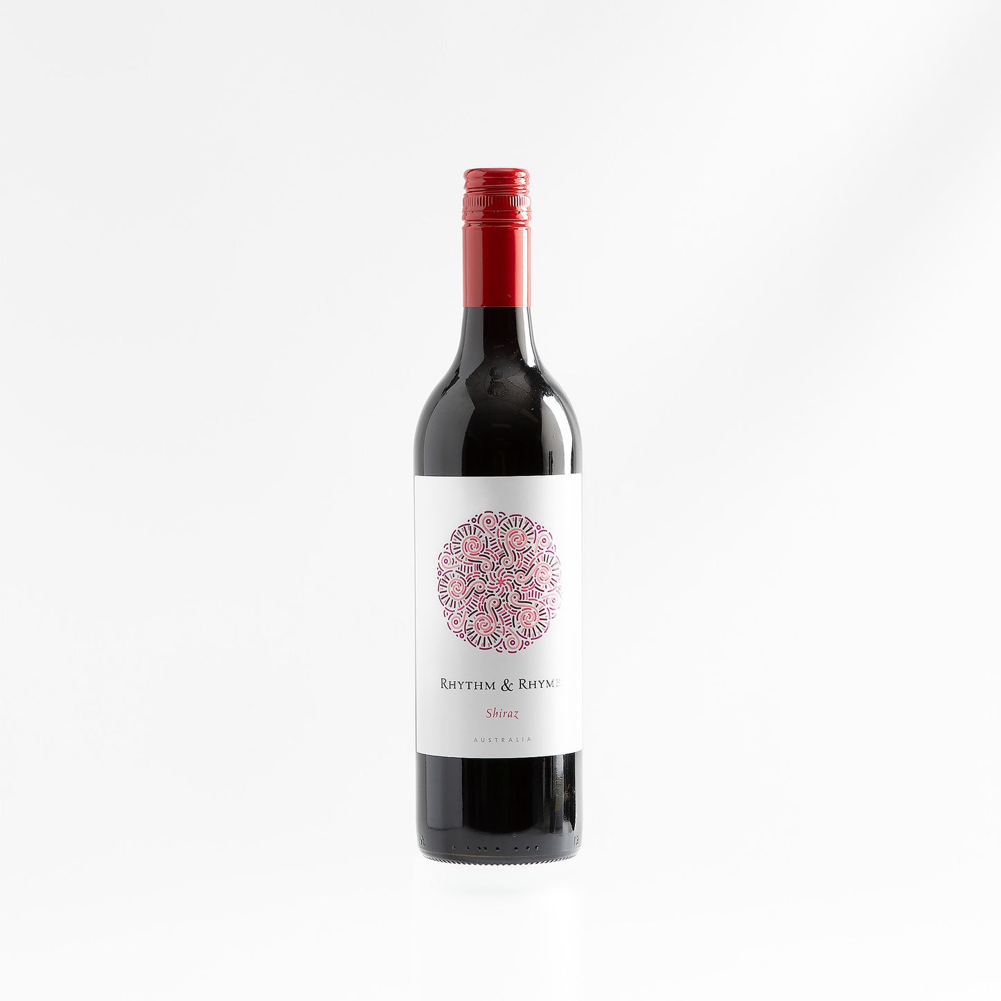 Bottle of red wine with a decorative label on a white background