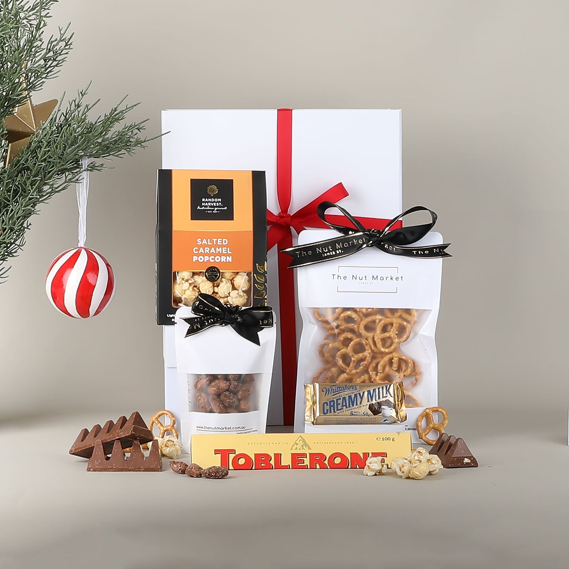Gift set with snacks and Toblerone chocolate on a neutral background