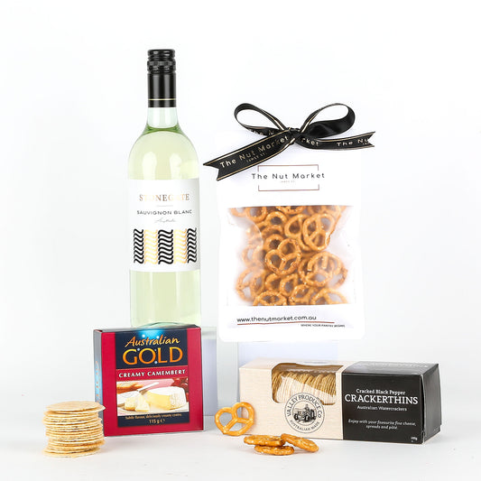 Wine bottle with cheese, crackers, and pretzels on a white background