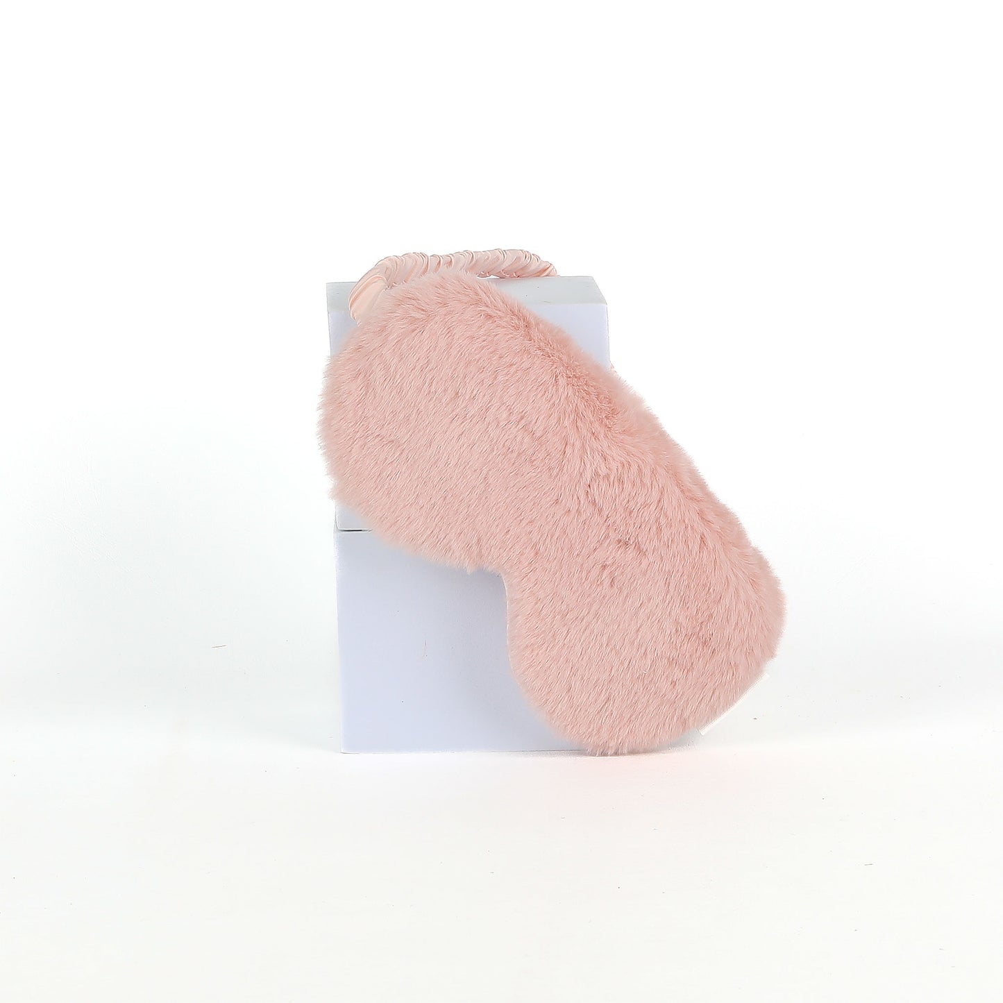 Pink fluffy eye mask on a white background