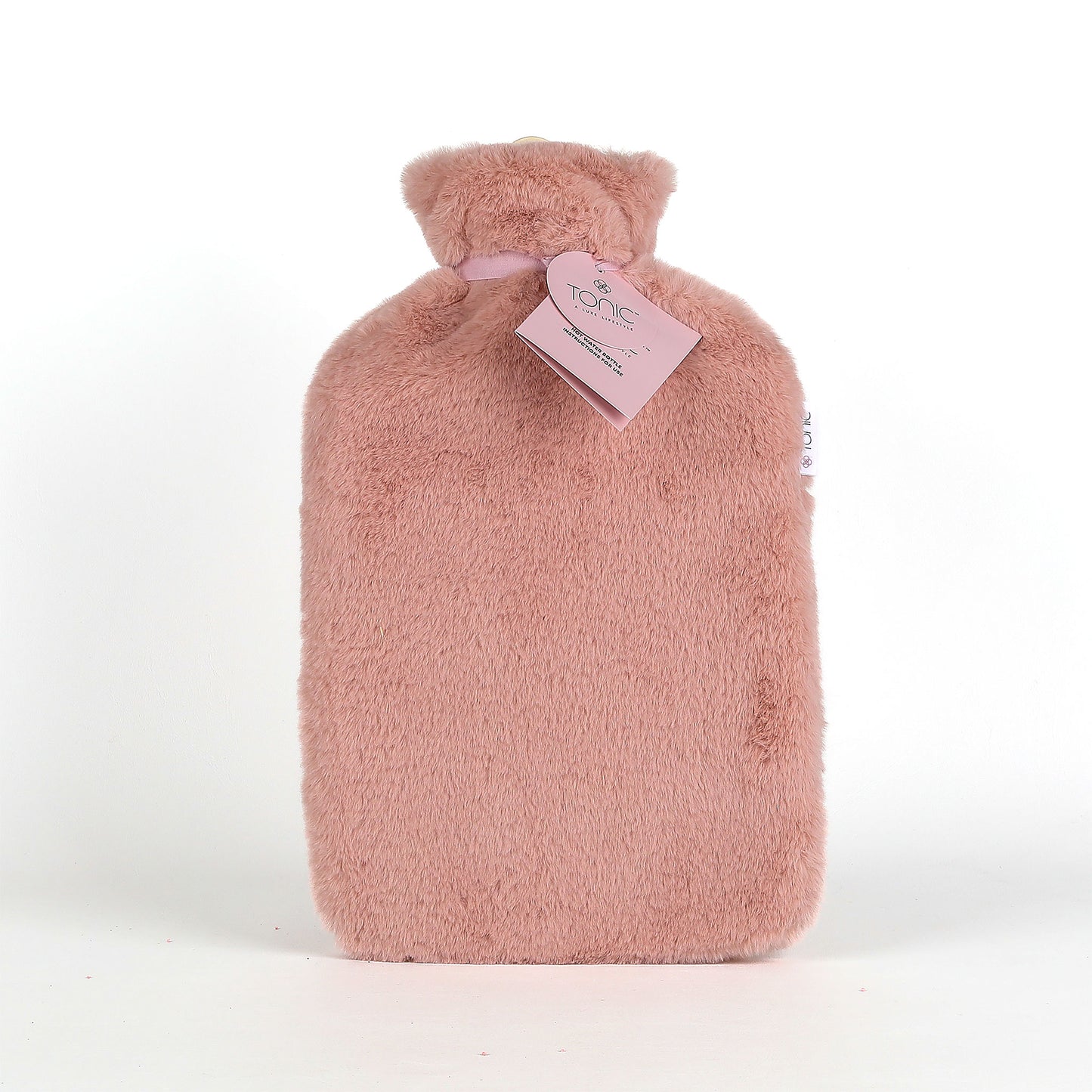 Pink hot water bottle with fuzzy cover and tag on a white background