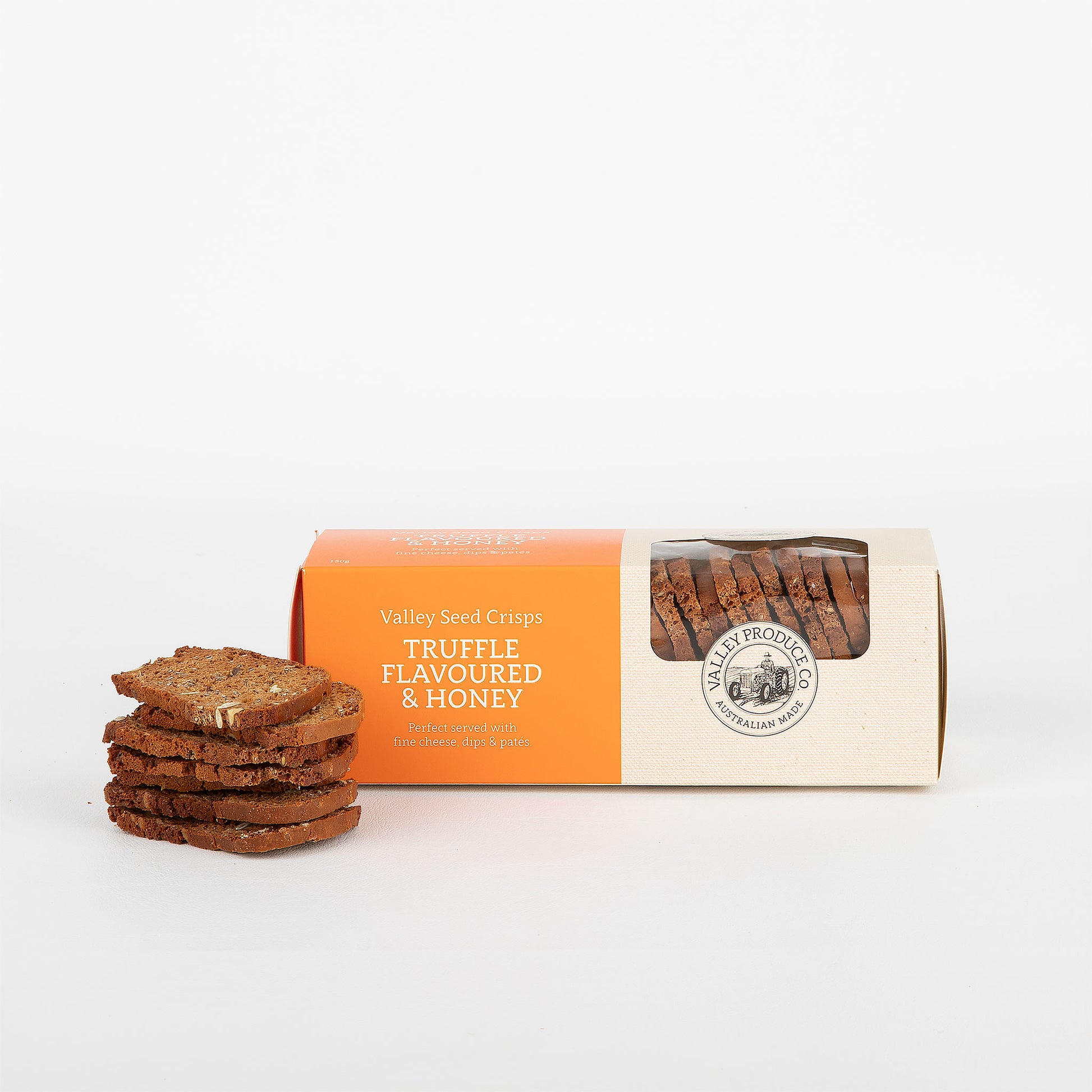 Box of truffle flavored & honey "Valley Seed Crisps" accompanied by a stack of the crisps on a white background.