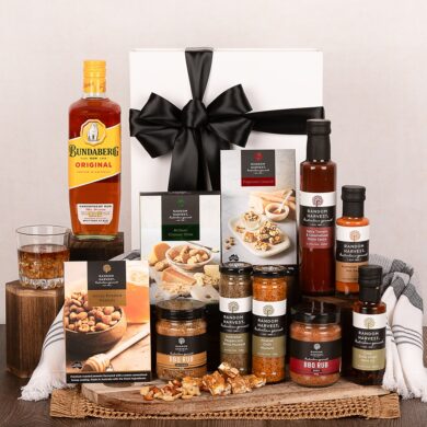 White gift hamper with Bundaberg Rum and a selection of Random Harvest gourmet BBQ products.